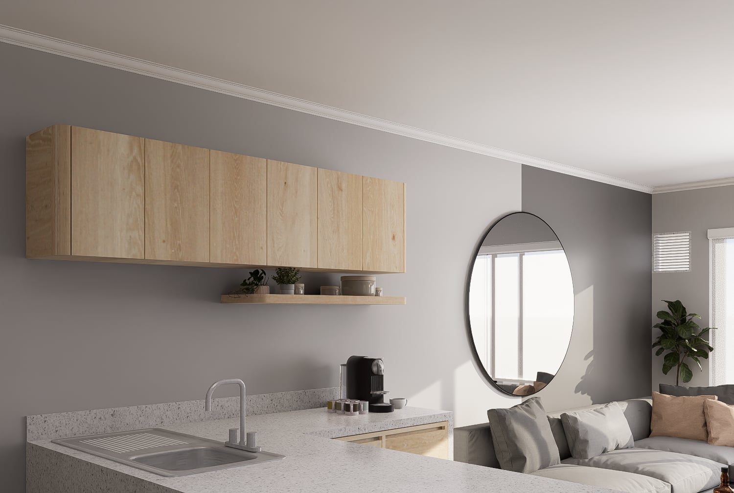 Estudio minimalista con cocina flotante, encimera de terrazo y sofá gris con espejo circular